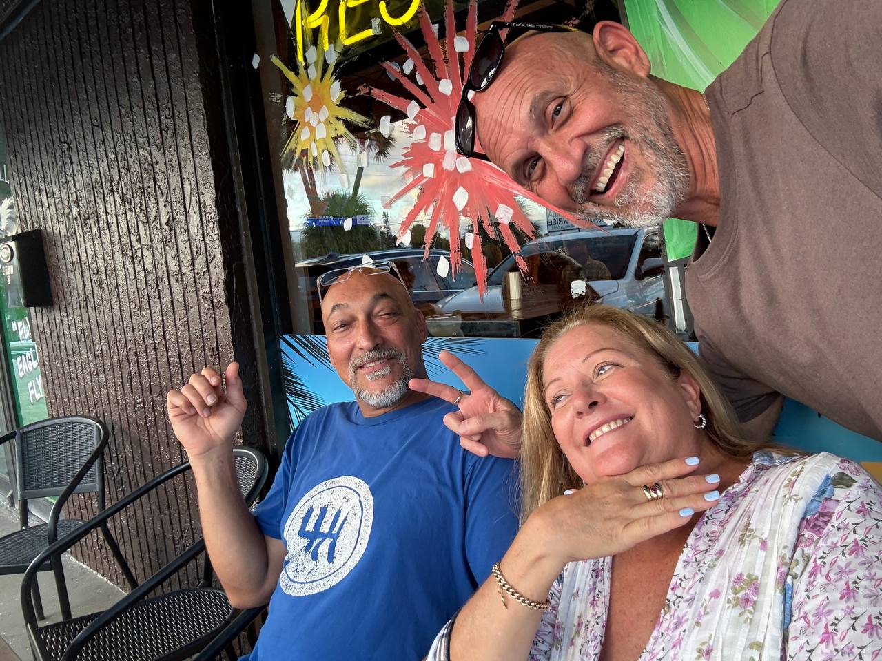 Three friends sharing a laugh on the patio.