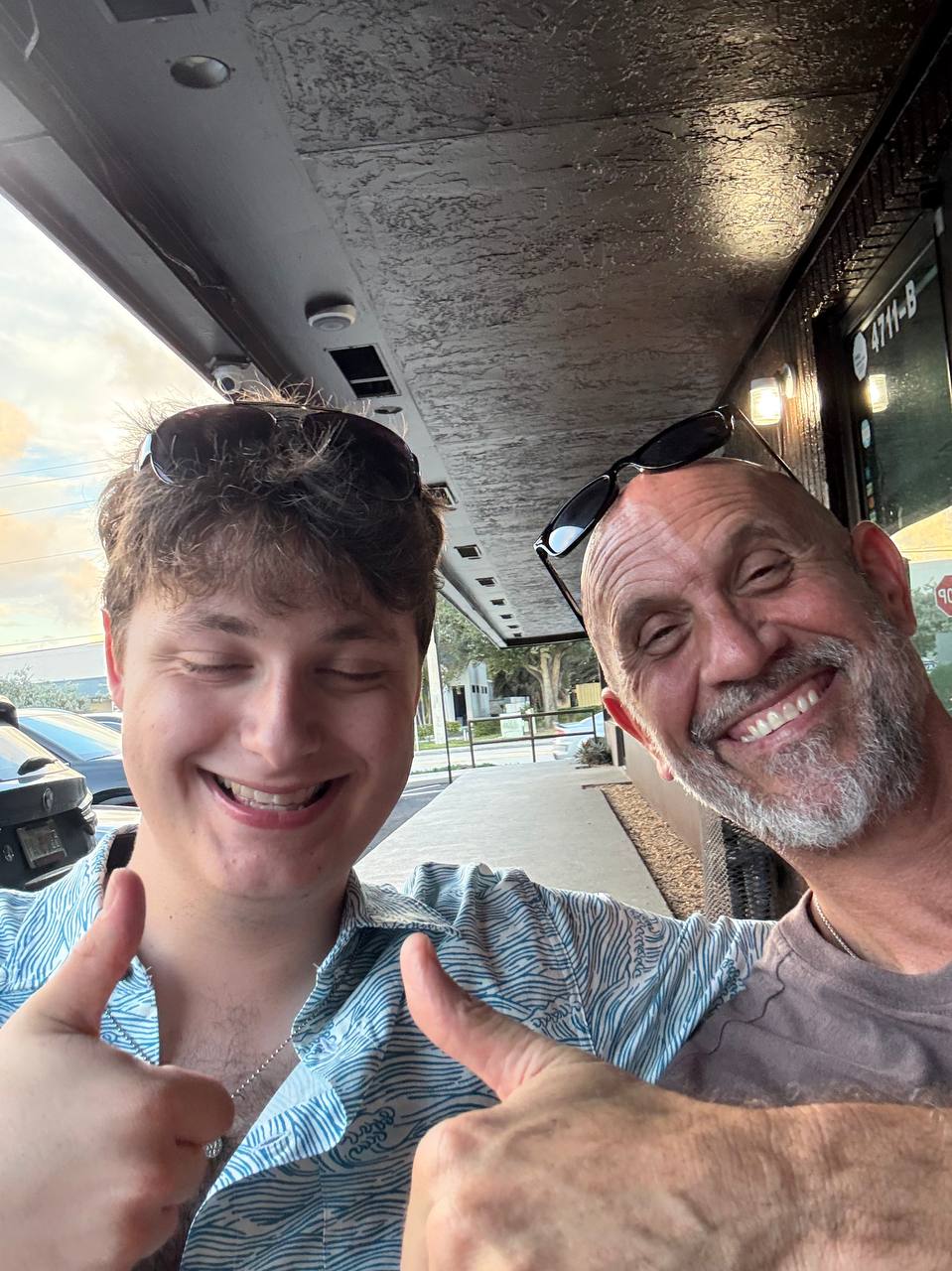 Two friends giving a thumbs-up.
